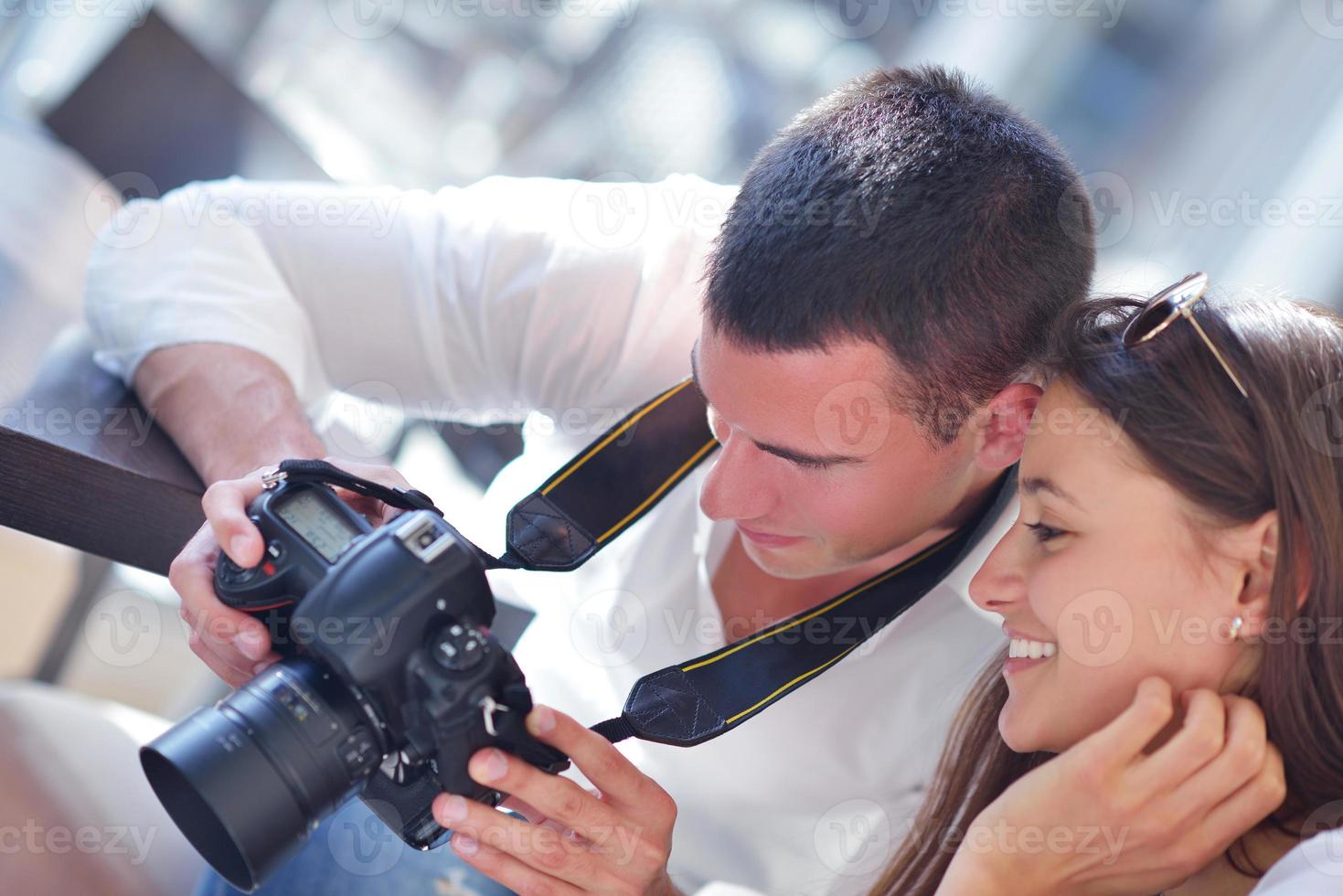 couple looking photos on camera