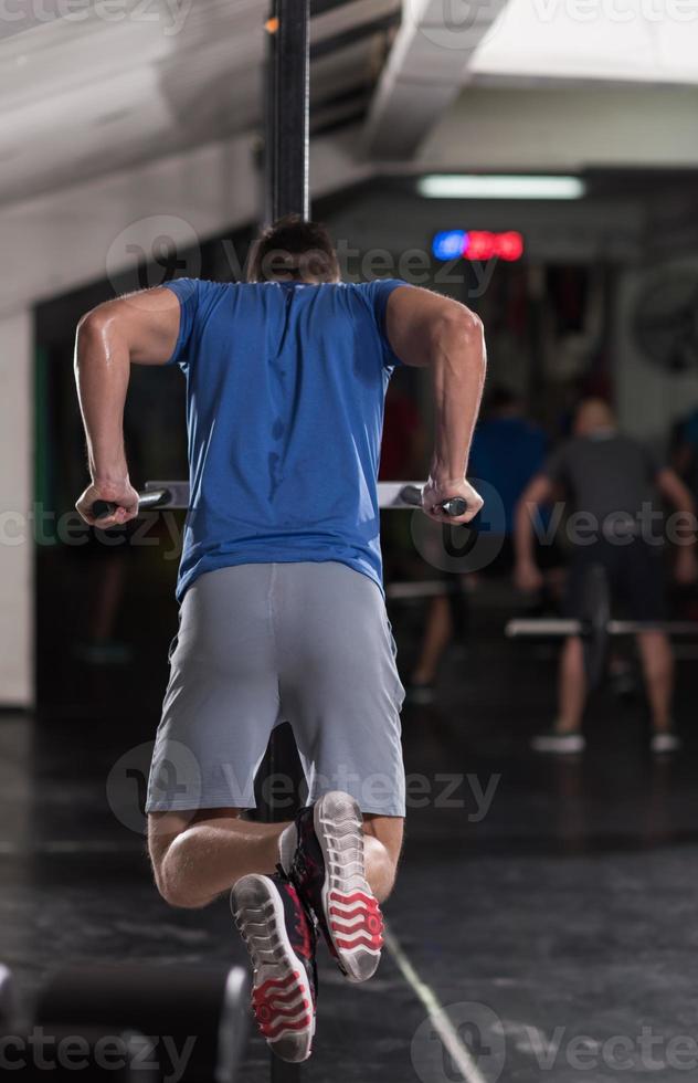 man doing exercises parallel bars photo