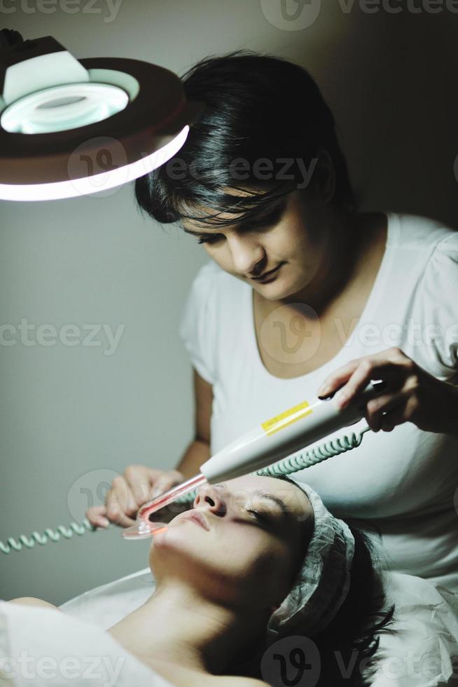 woman with facial mask in cosmetic studio photo