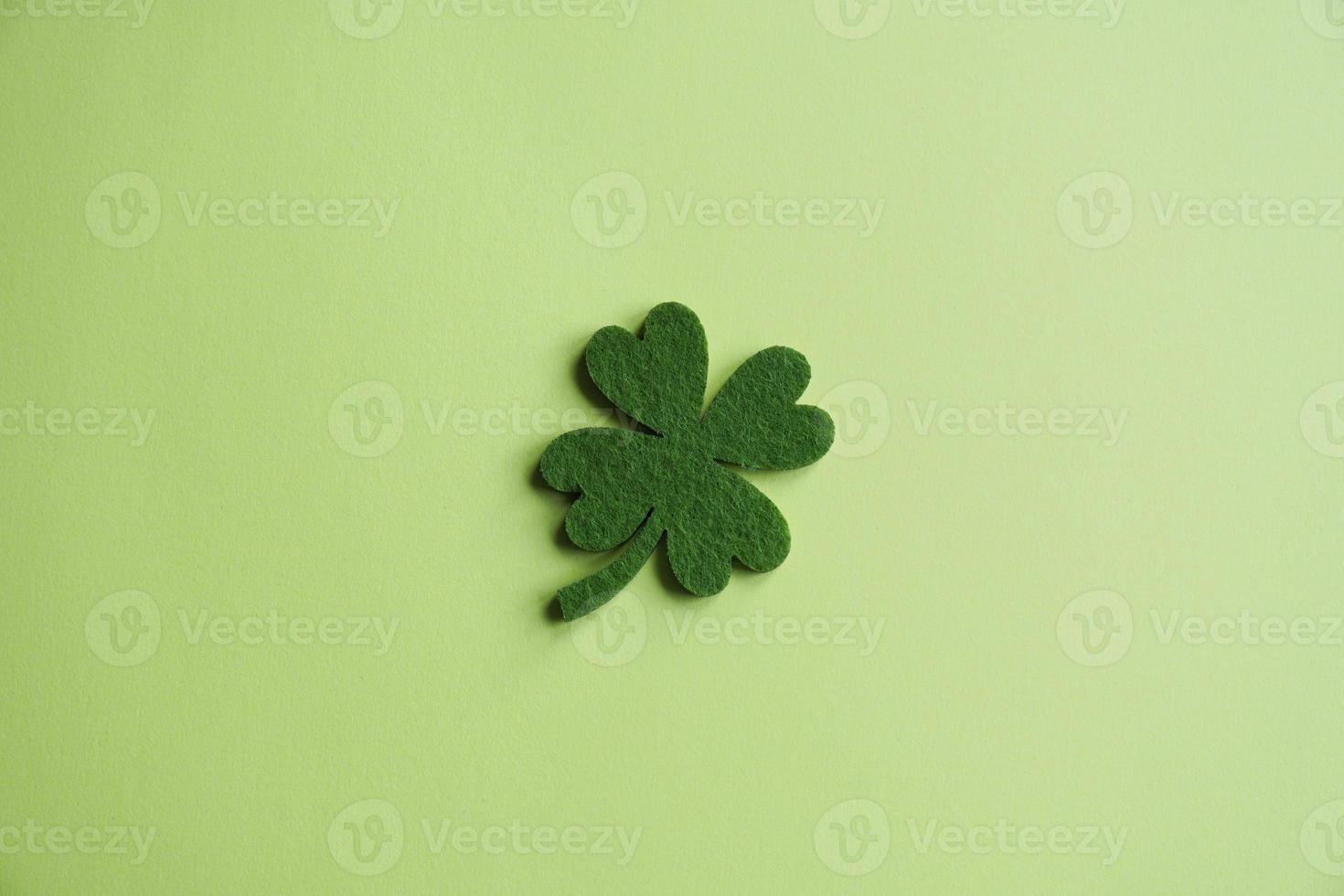 four-leaf clover made from felt on green background photo