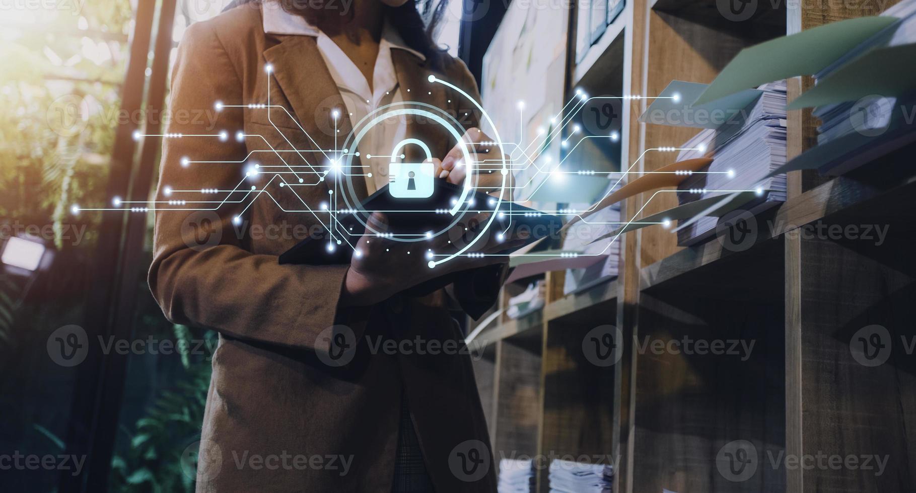 Cybersecurity and privacy concepts to protect data. Lock icon and internet network security technology. Businessman protecting personal data on smart phone with virtual screen interfaces. photo