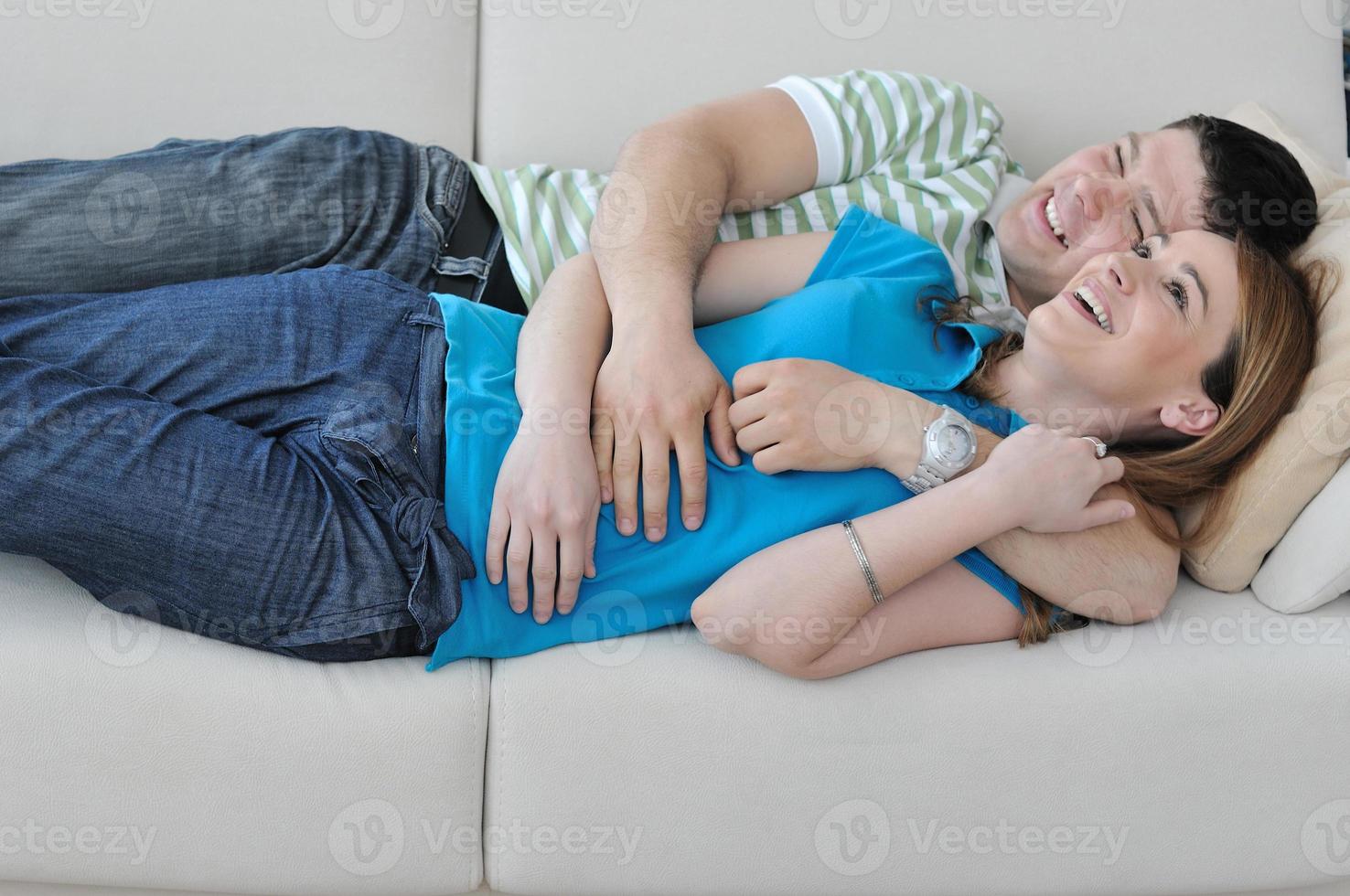 couple relax at home on sofa in living room photo