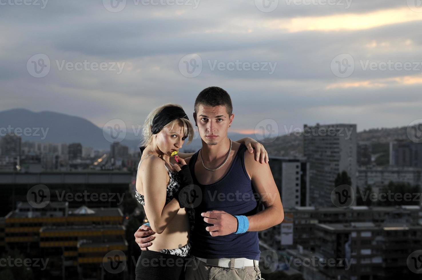 romantic urban couple dancing on top of the bulding photo