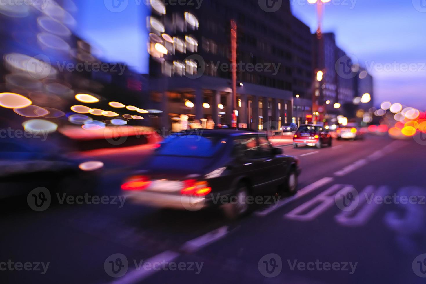 City night with cars motion blurred light in busy street photo