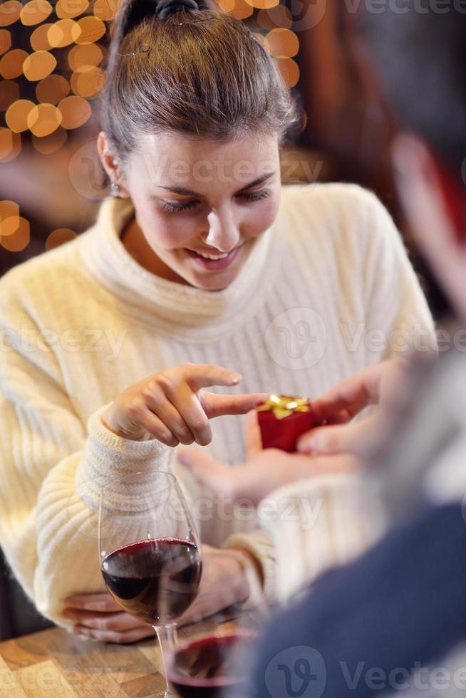 young man gives a gift to girl photo