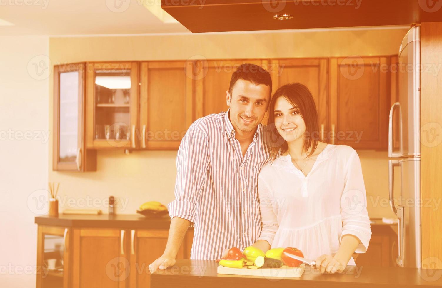 feliz pareja joven divertirse en la cocina moderna foto