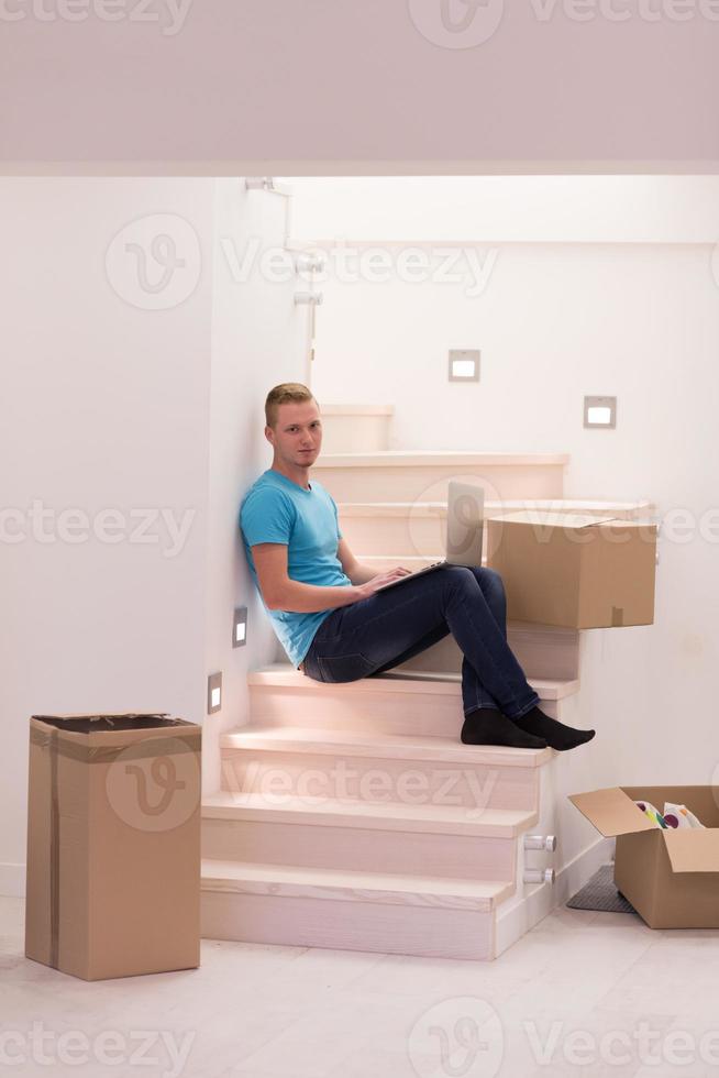 young man sitting in stairway at home photo