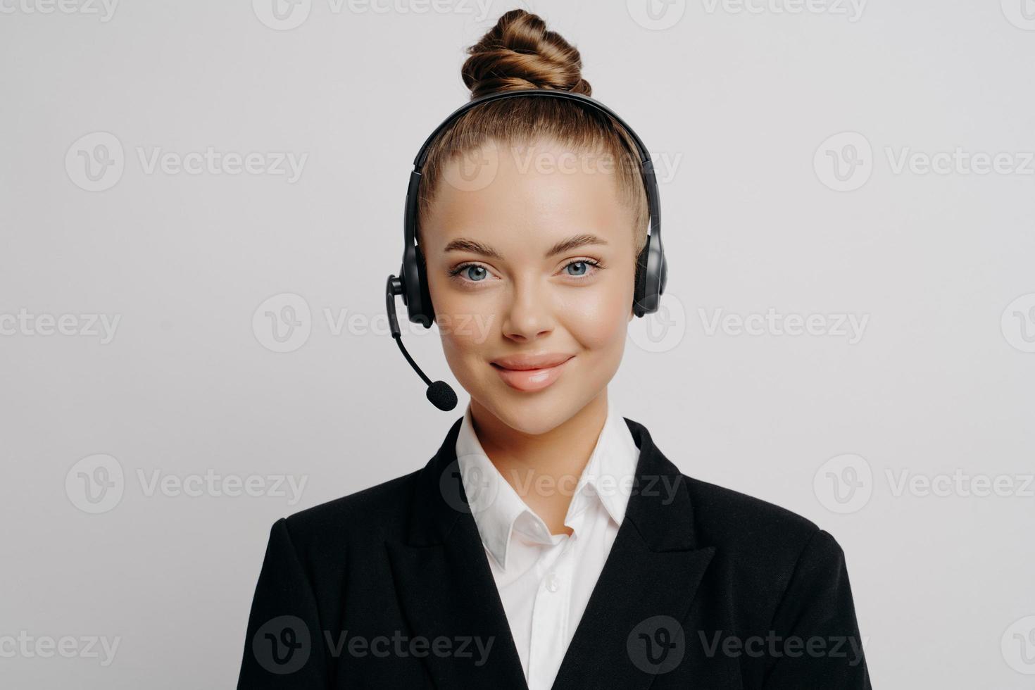 Female customer service representative in dark suit listening to customer photo