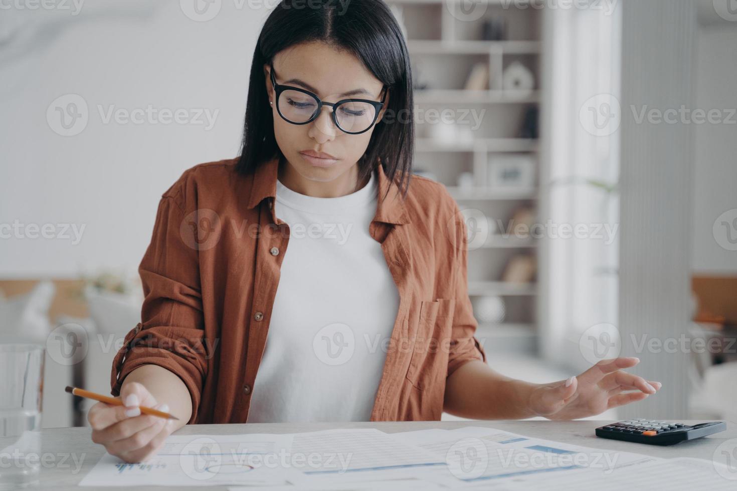 el gerente o asistente de negocios está sentado en el escritorio y haciendo su trabajo con el papeleo en casa. foto