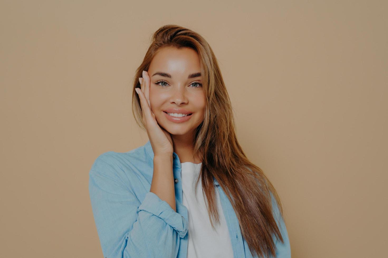 Close up portrait of positive happy woman in white tshirt and blue shirt photo