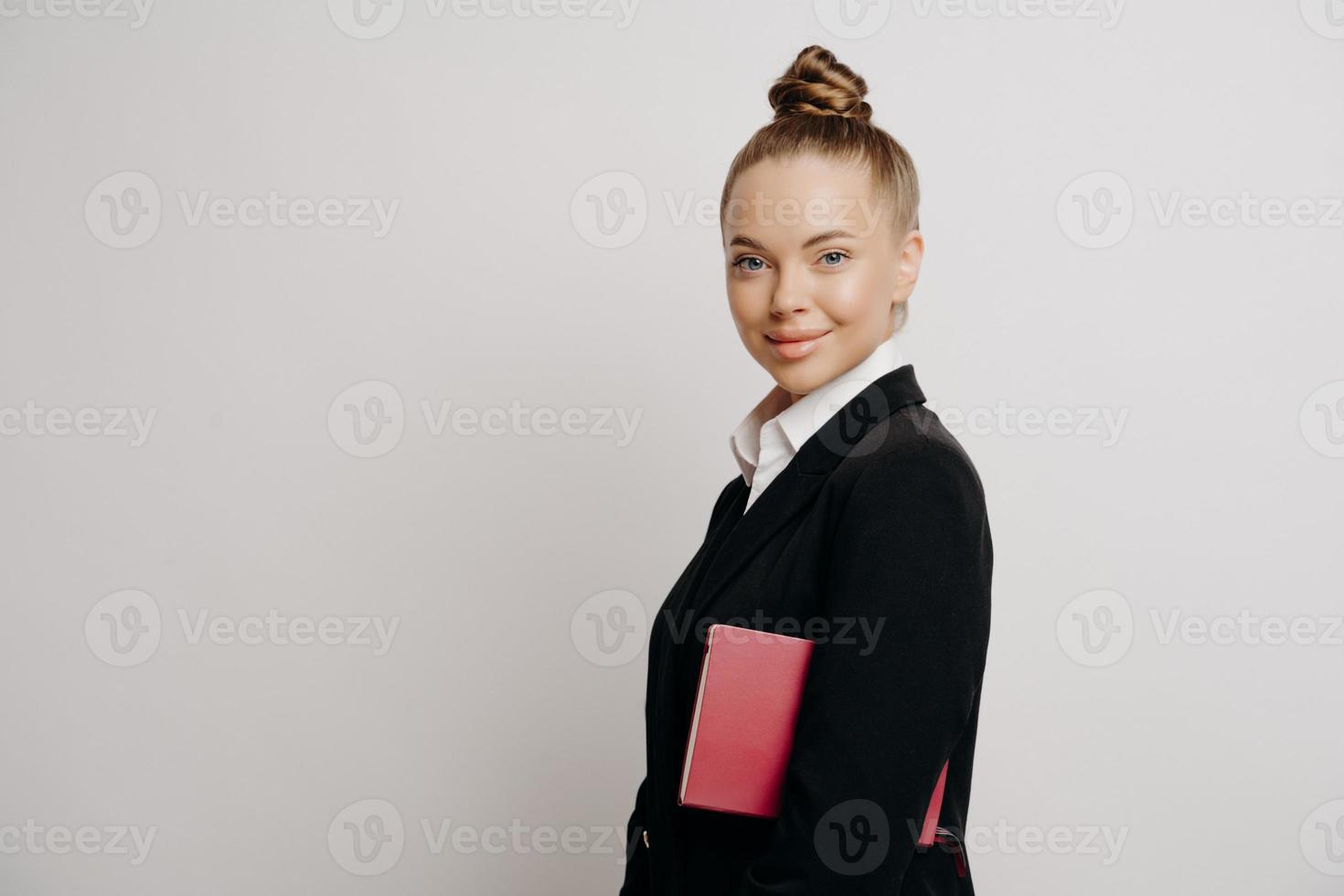 Bussiness woman in dark suit with confident look photo