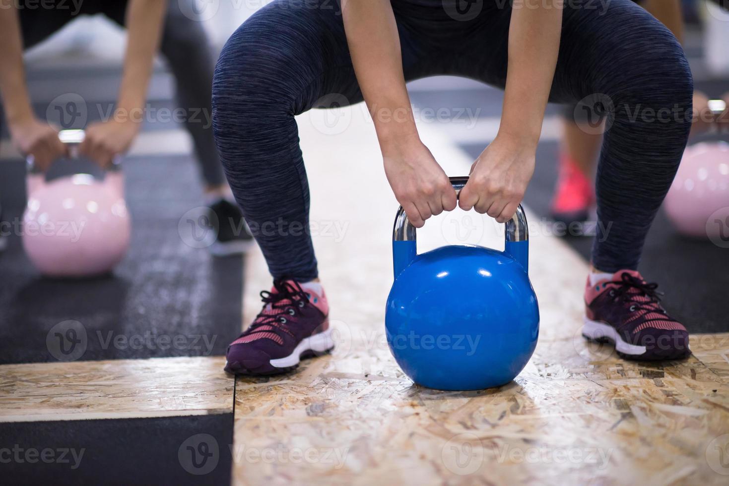 athletes doing exercises with kettlebells photo