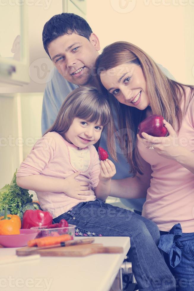 happy young family in kitchen photo