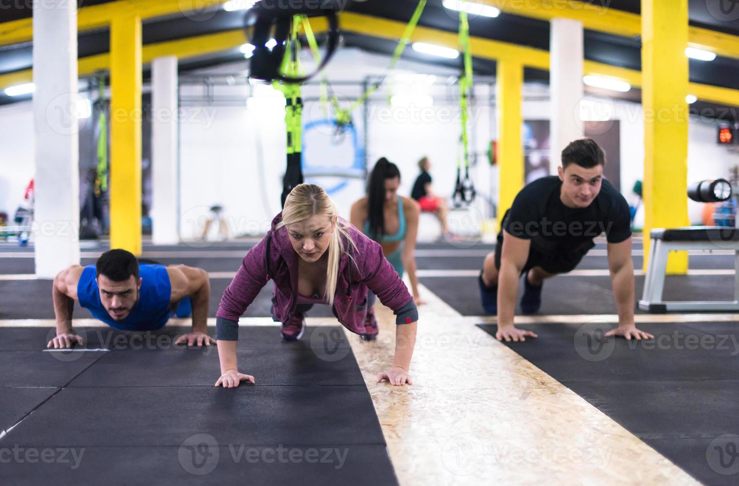 young healthy people doing pushups photo