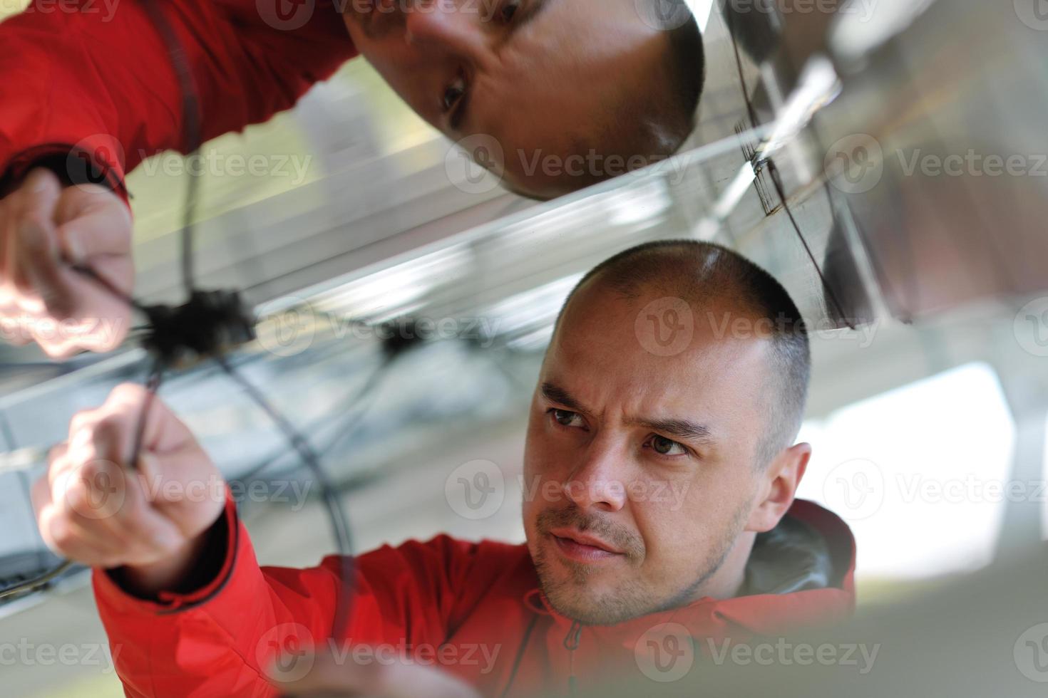 Male solar panel engineer at work place photo