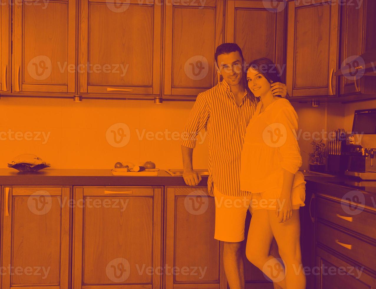 happy young couple have fun in modern kitchen photo