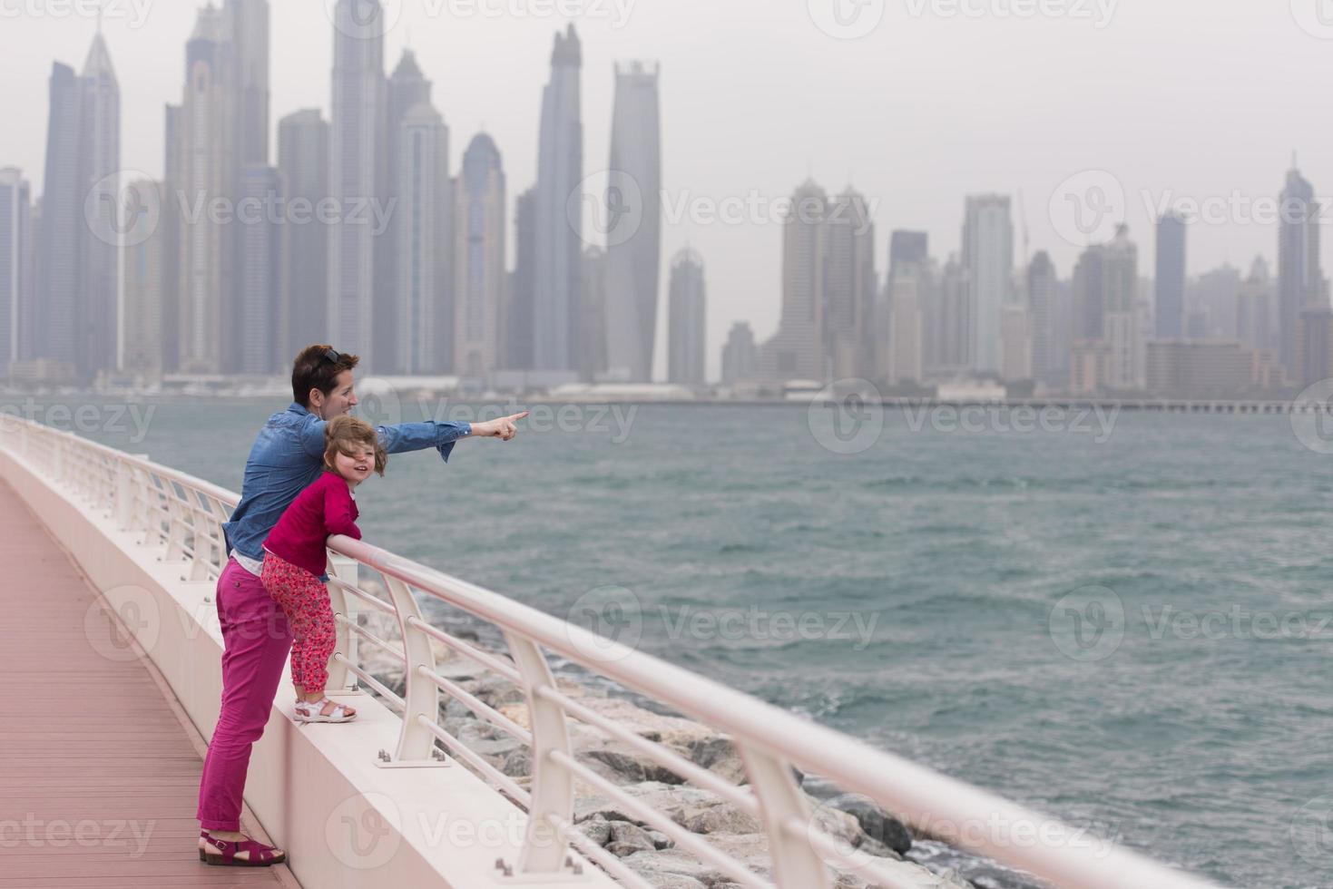 mother and cute little girl on the promenade photo