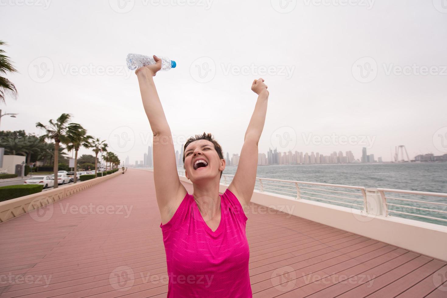 young woman celebrating a successful training run photo