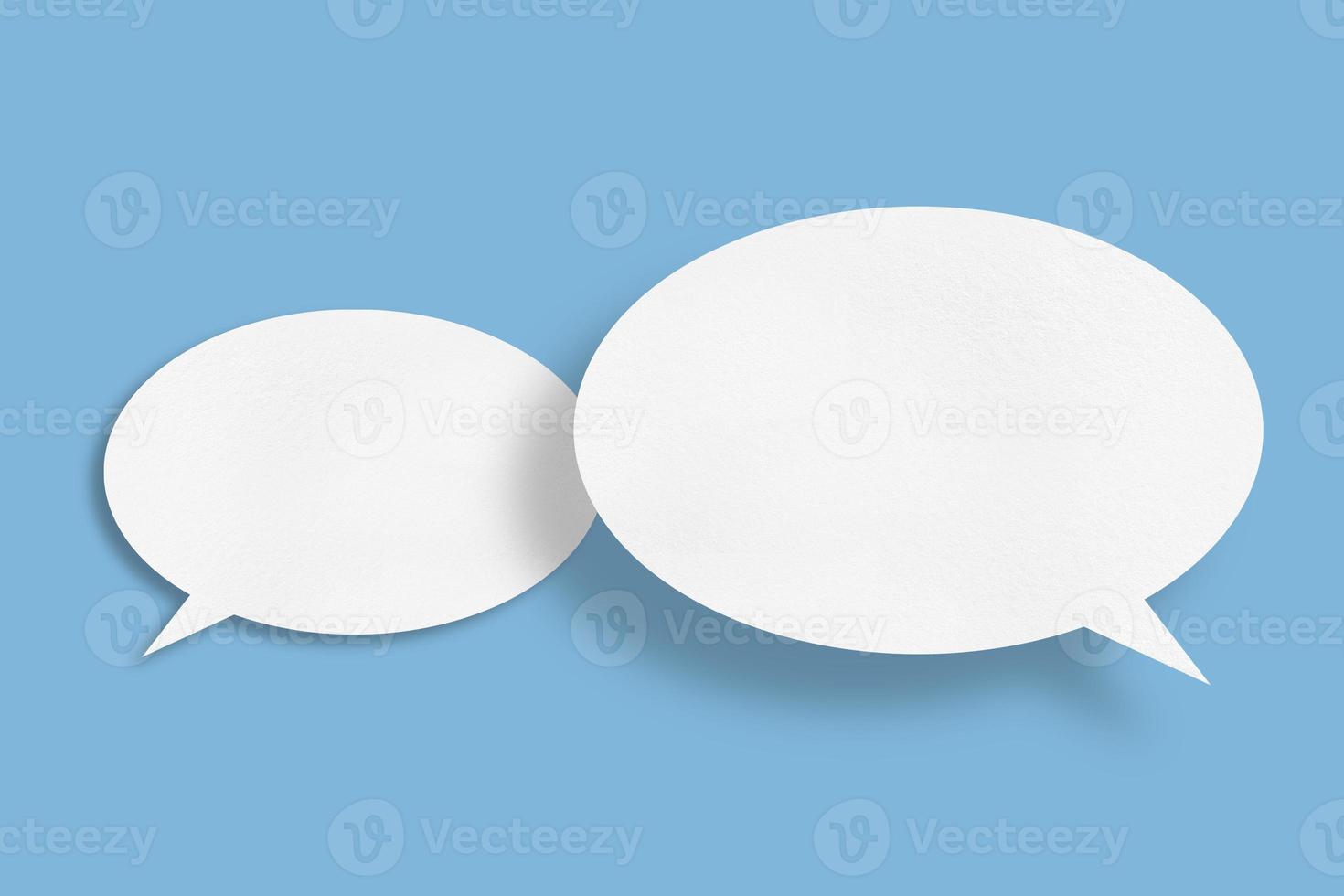 white paper with speech bubbles isolated on blue background communication bubbles photo