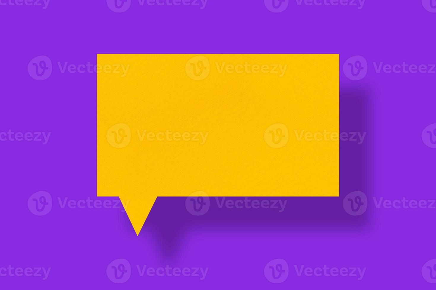 Speech balloon square yellow paper against purple background. photo