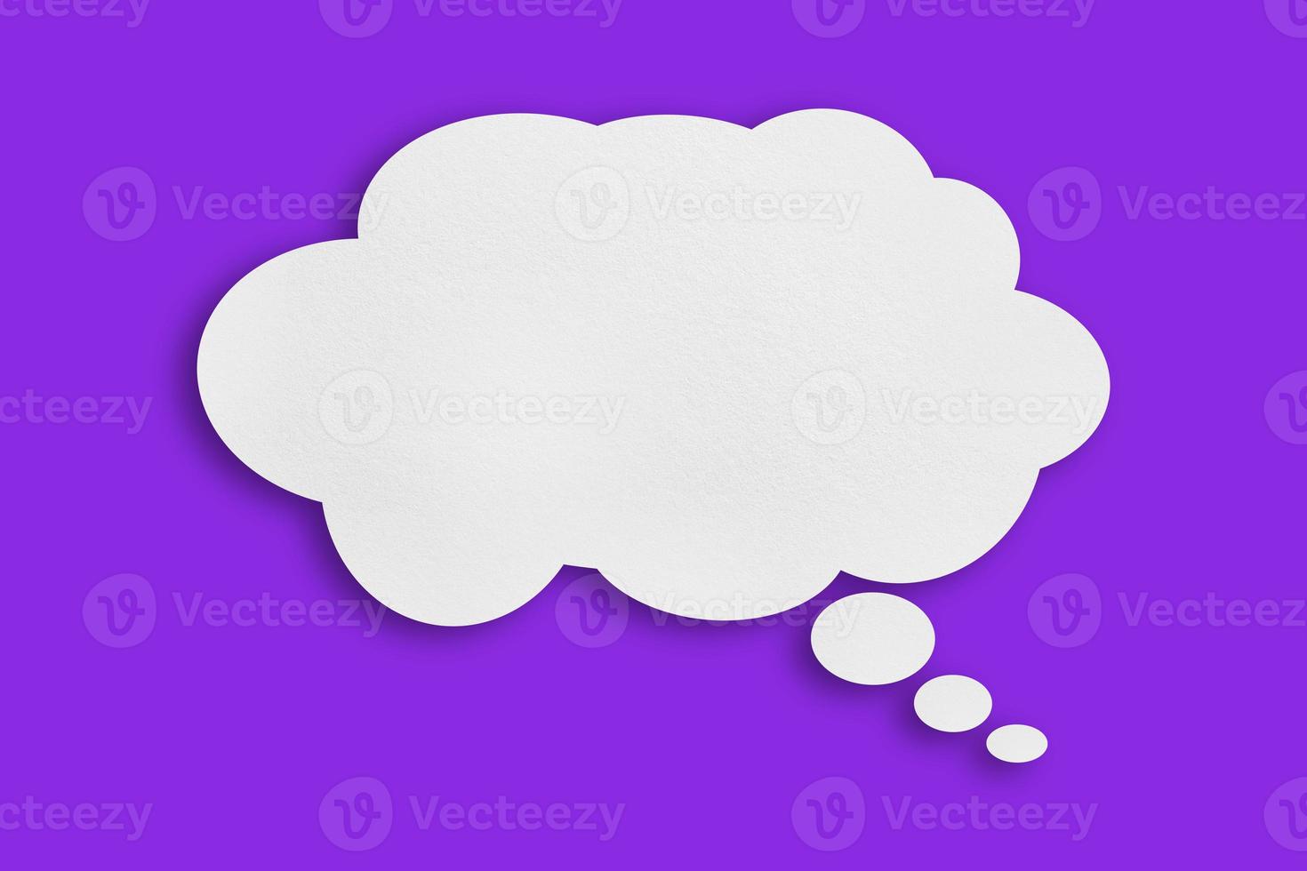 white cloud paper speech bubble shape against purple background photo