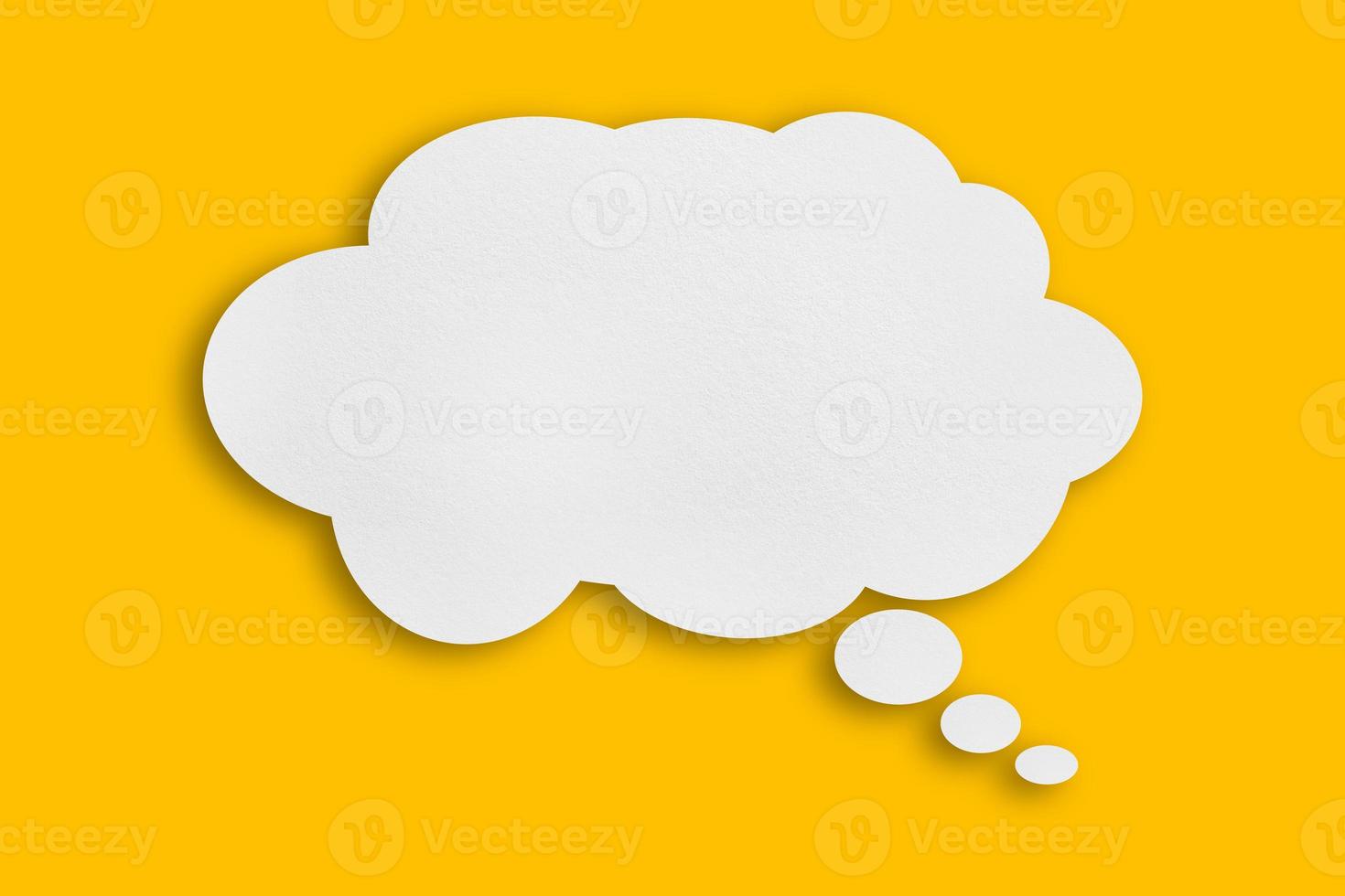 white cloud paper speech bubble shape against yellow background photo