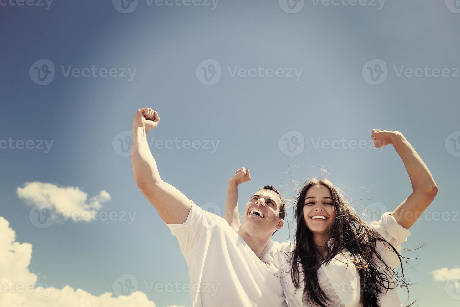happy couple have fun on the beach photo