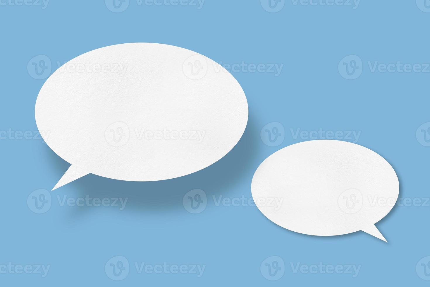 white paper with speech bubbles isolated on blue background communication bubbles photo