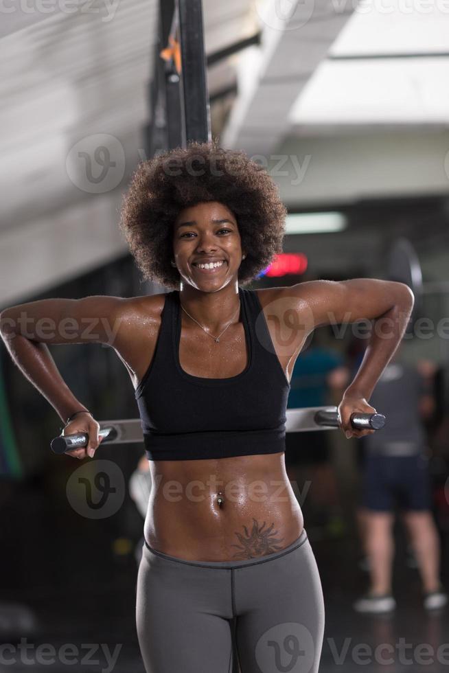 black woman doing parallel bars Exercise photo