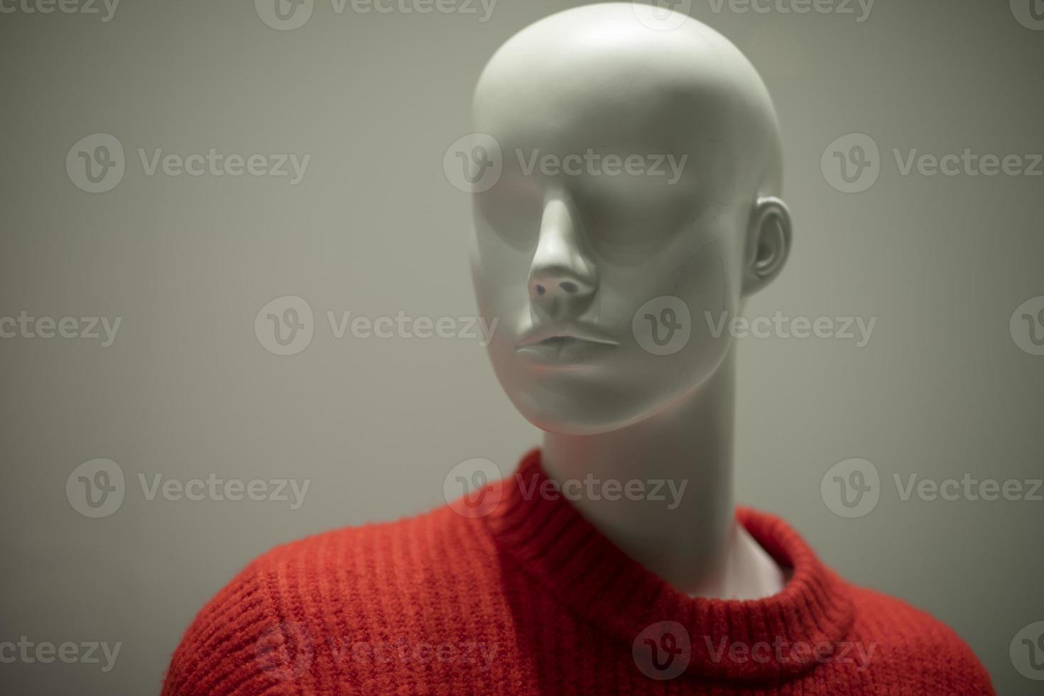 Mannequin in a red sweater. Shop window. Wool-bound clothing. photo