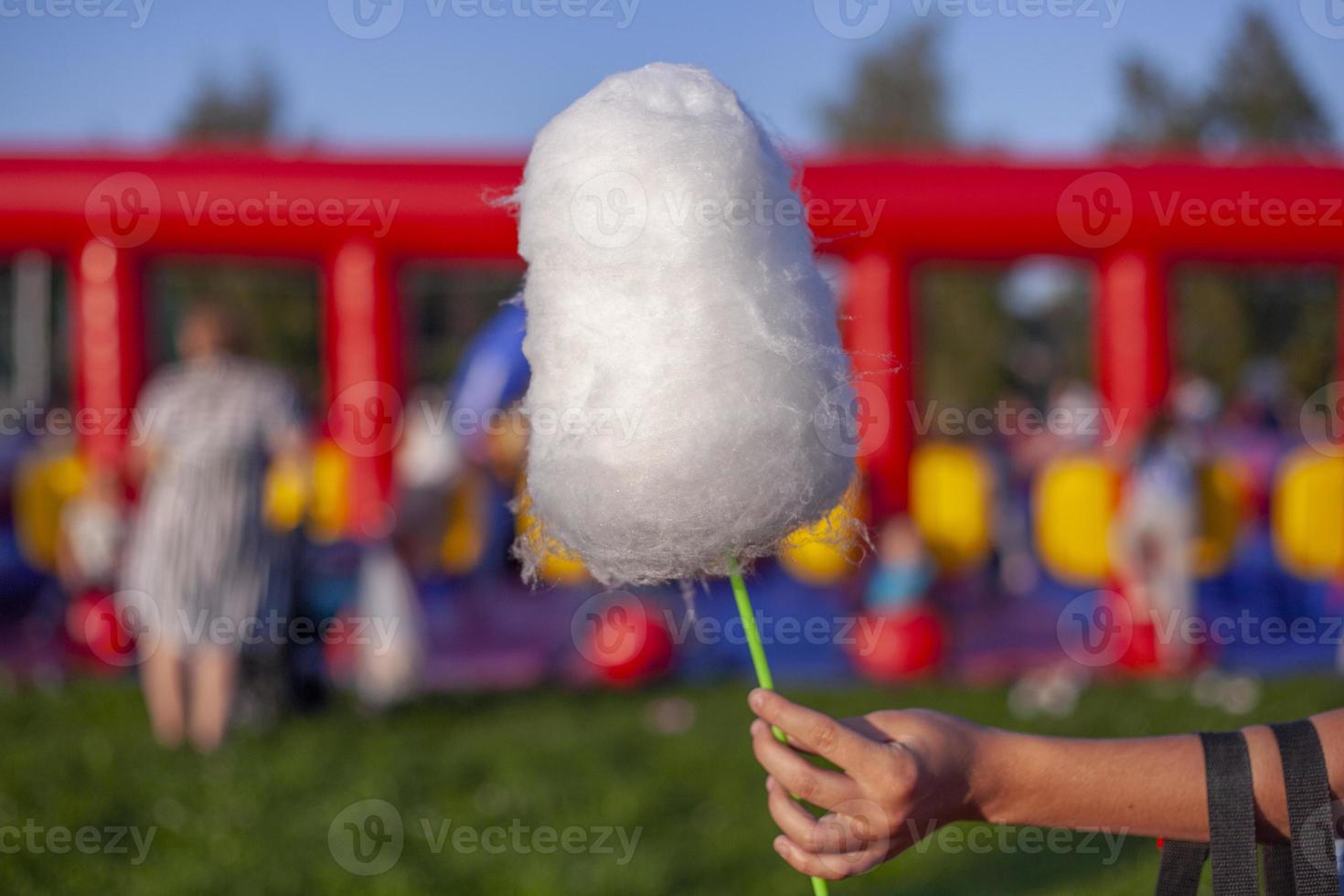 Cotton candy on stick. Sweetness on street. photo