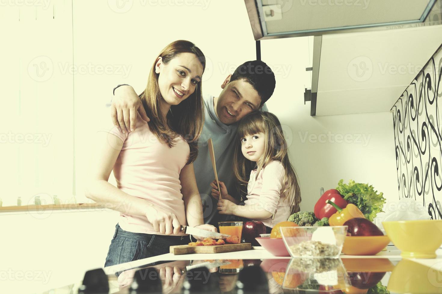 happy young family in kitchen photo