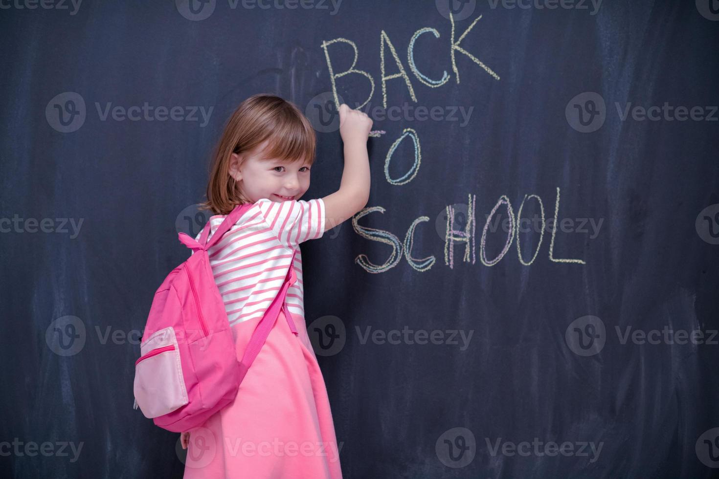 school girl child with backpack writing chalkboard 11318558 Stock Photo