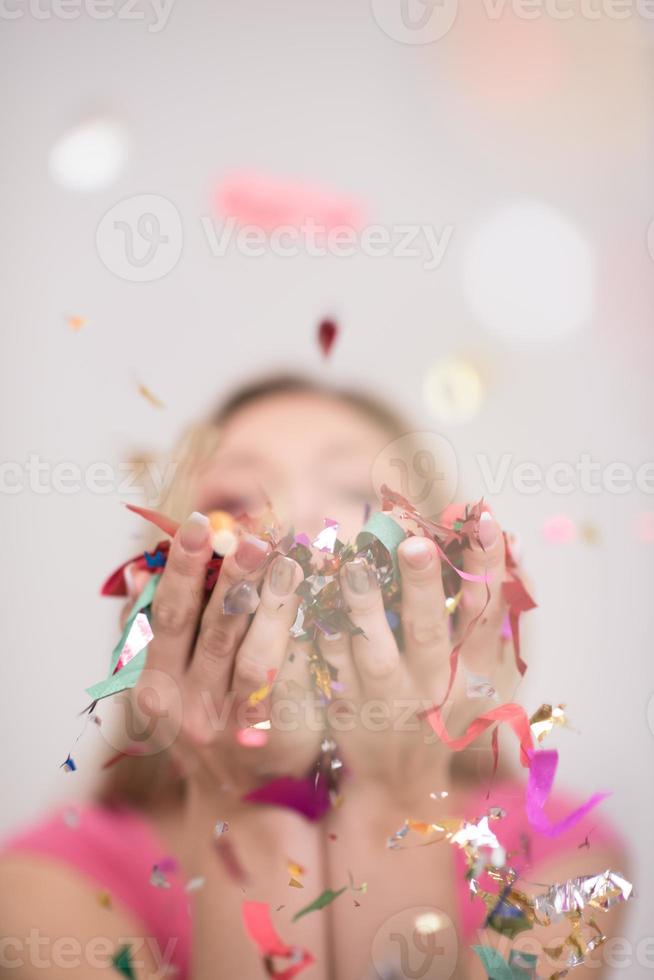 woman blowing confetti in the air photo