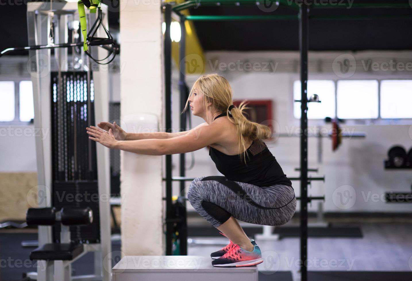 woman working out  jumping on fit box photo