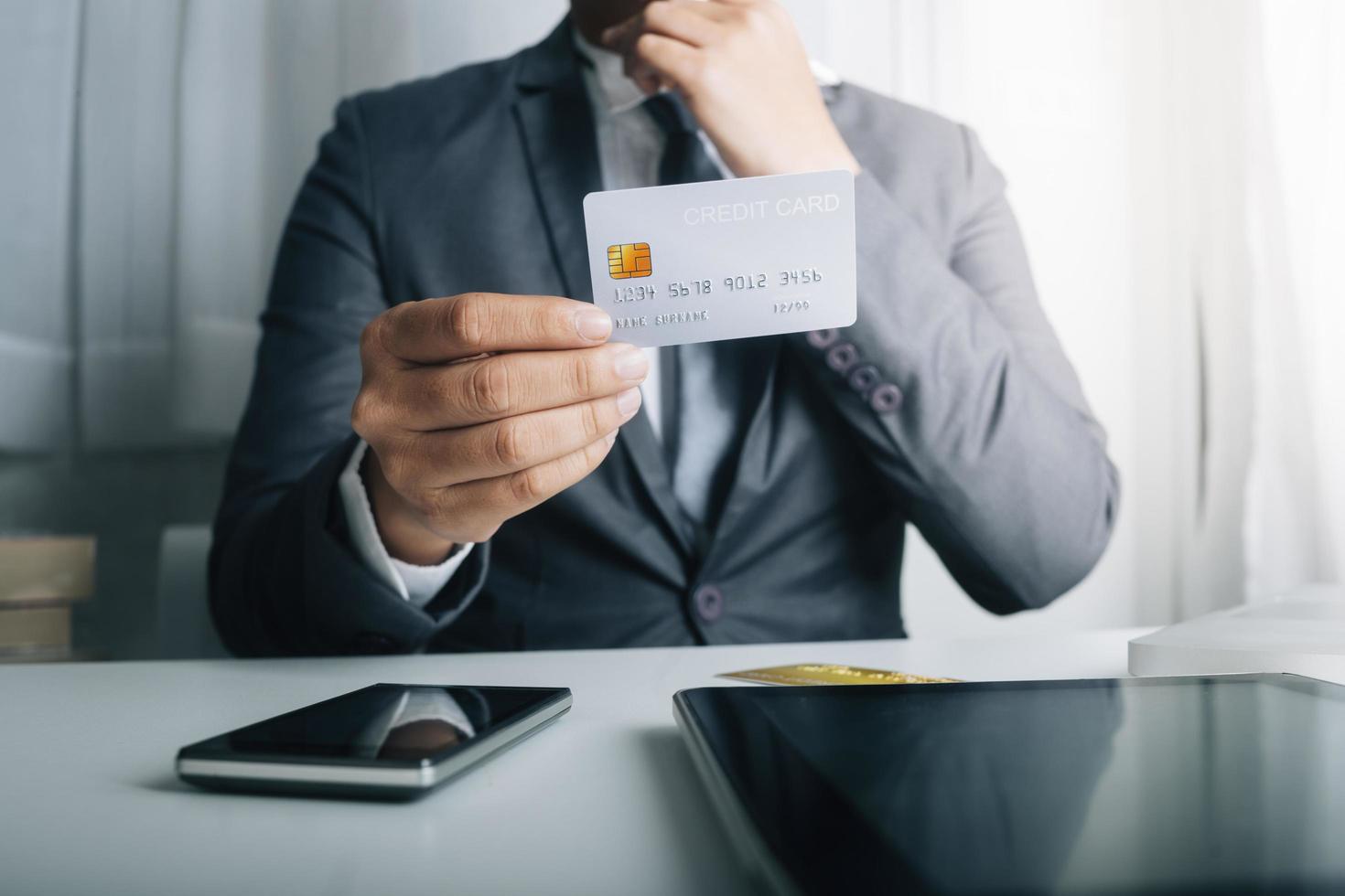 technology, people and online shopping concept - happy smiling man with tablet pc computer and credit card at home photo