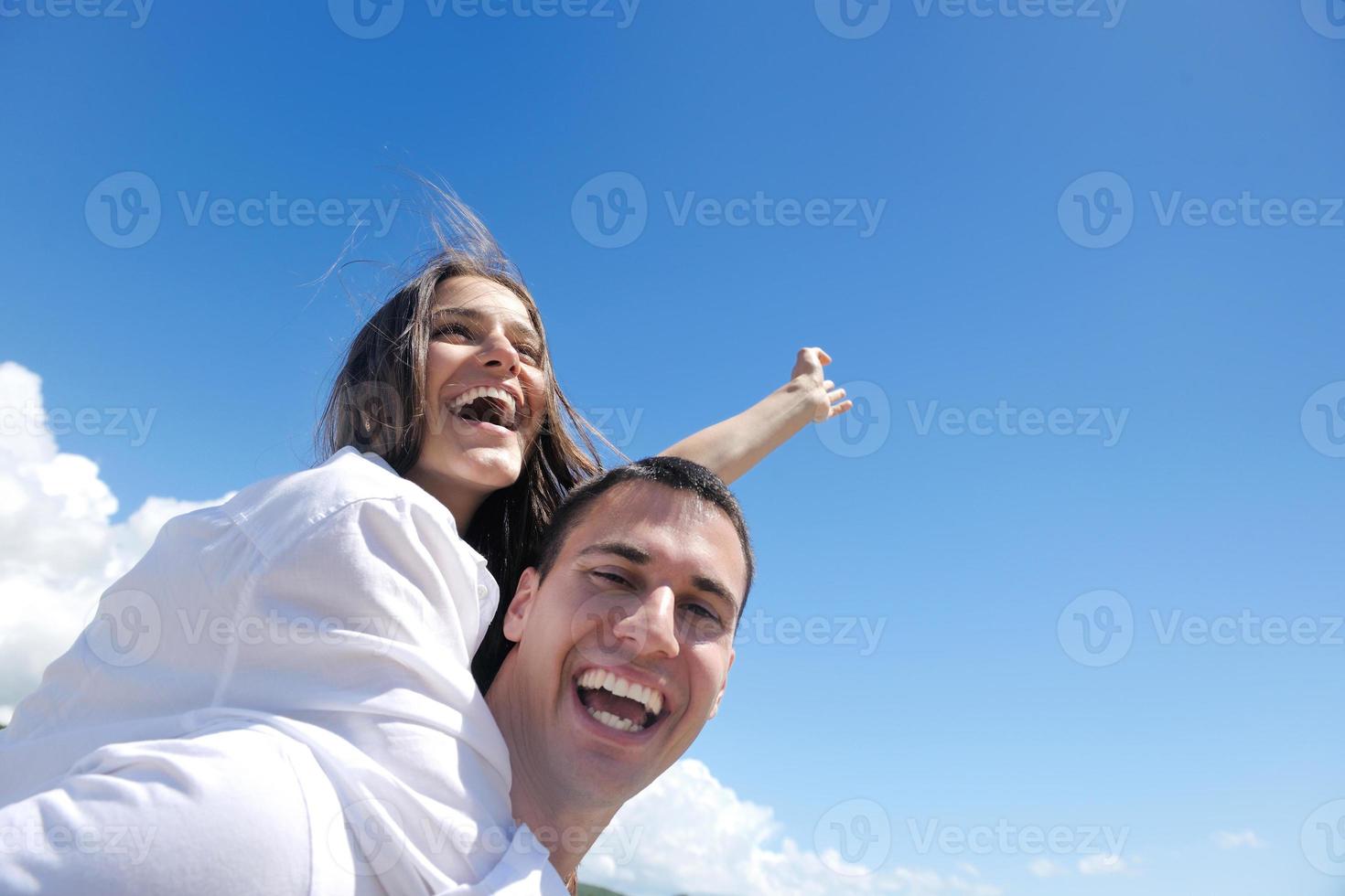 happy young couple have fun on beach photo
