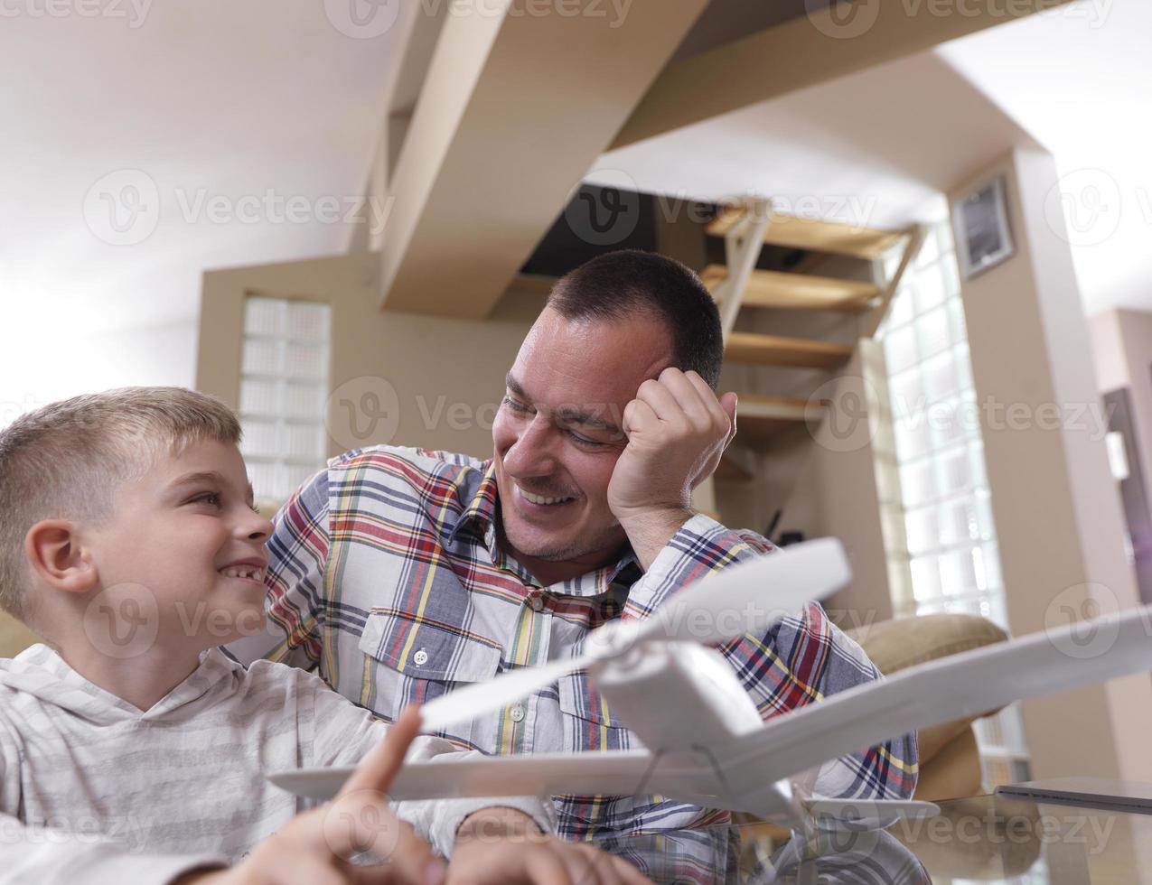 father and son assembling airplane toy photo