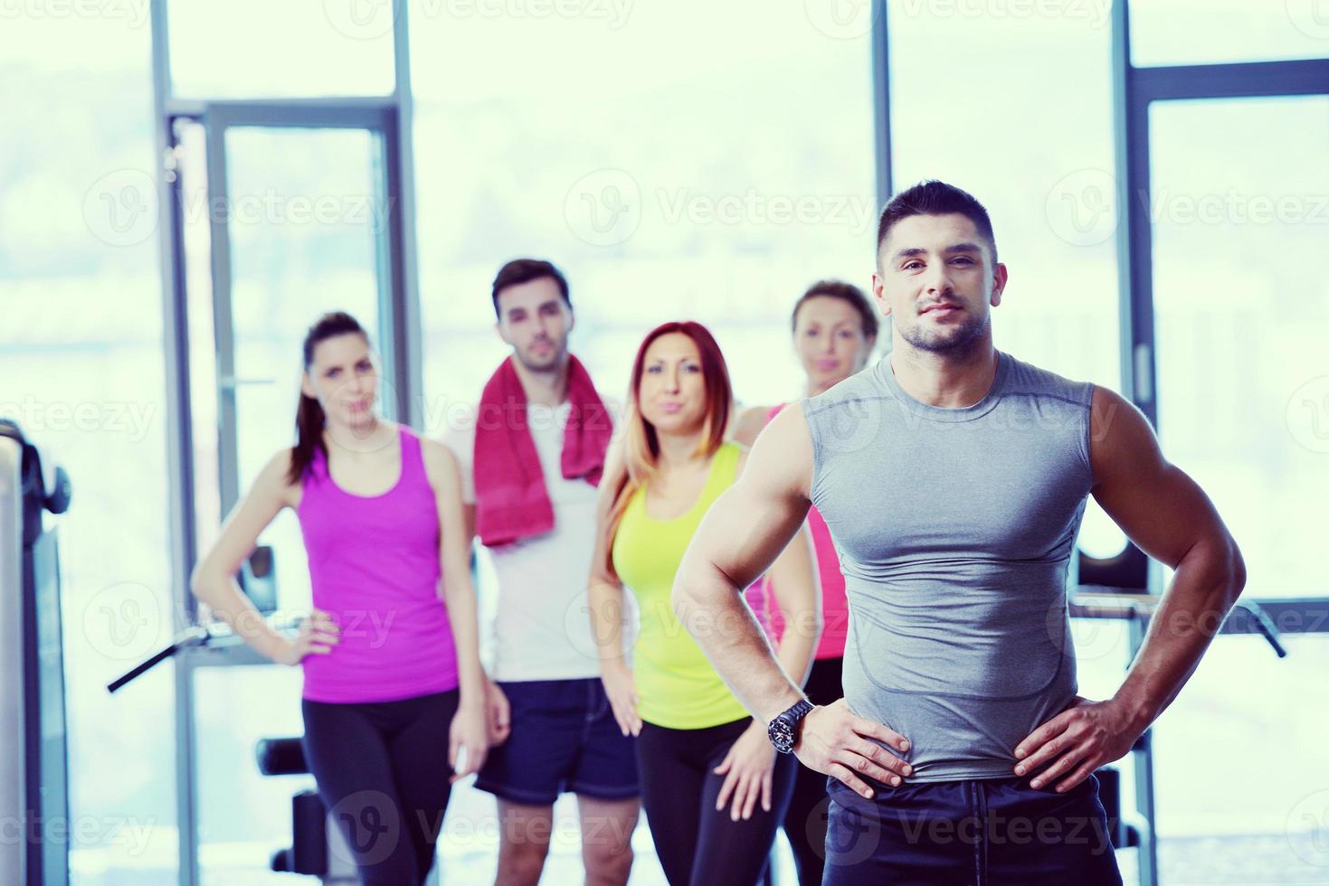 Group of people exercising at the gym photo