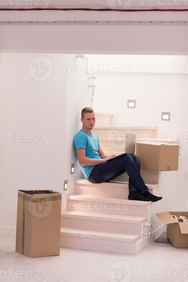 young man sitting in stairway at home photo