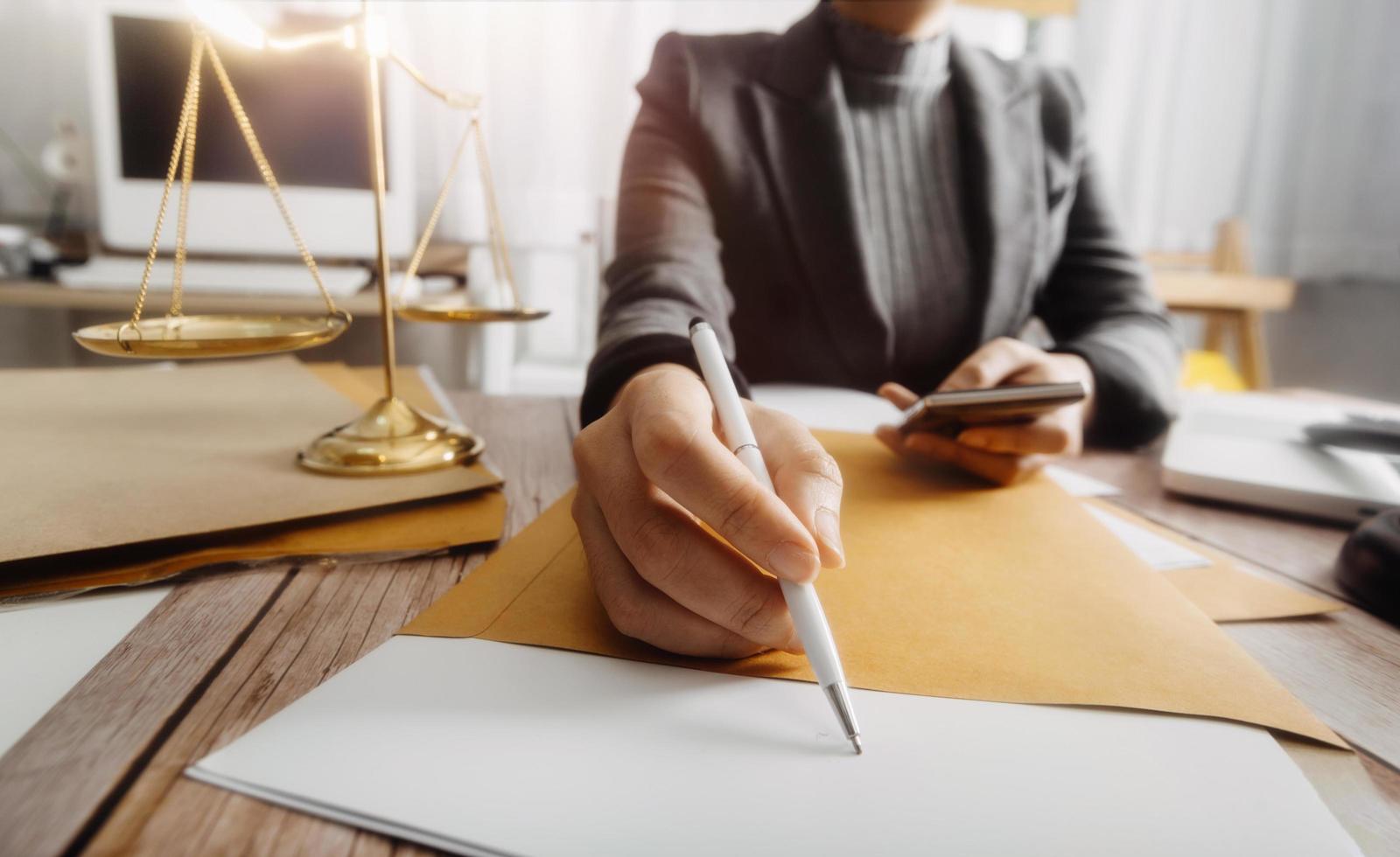 Business and lawyers discussing contract papers with brass scale on desk in office. Law, legal services, advice, justice and law concept picture with film grain effect photo