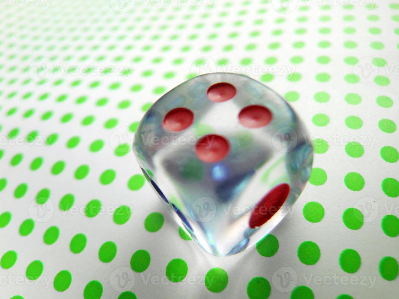 gambling dice on green dotted background photo