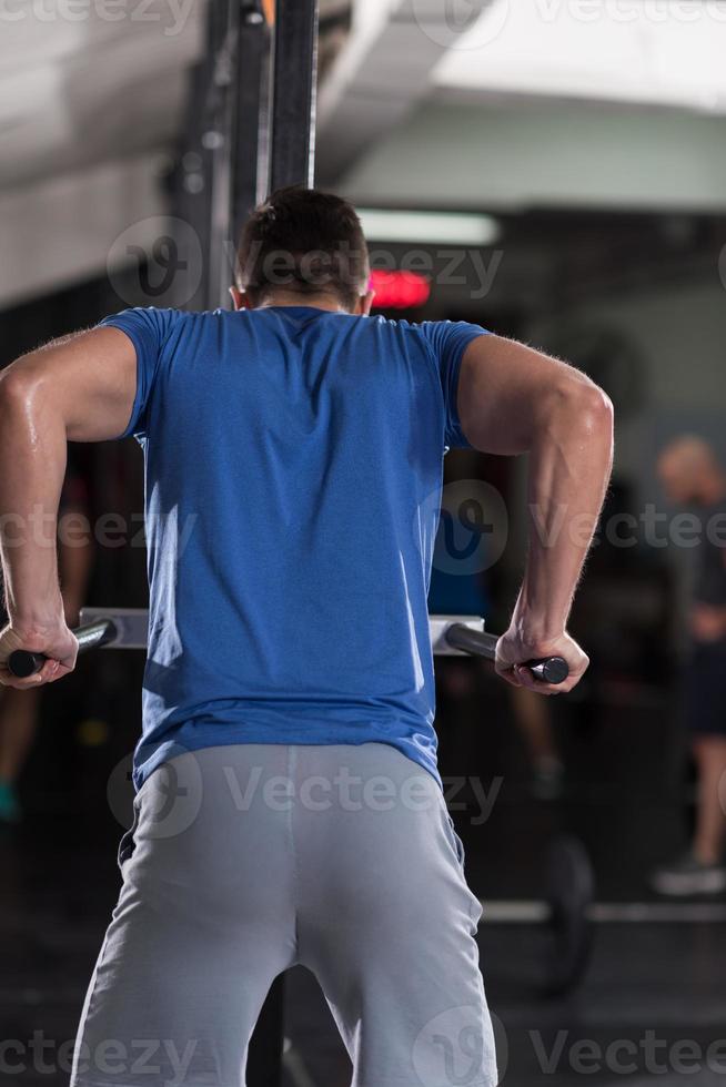 man doing exercises parallel bars photo