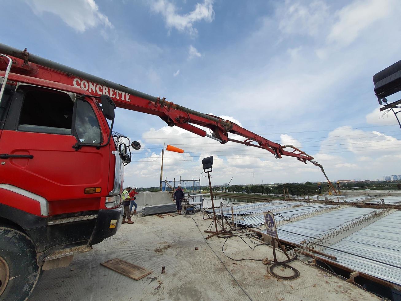 This is a process of casting concrete using a concrete pump to reach casting locations that are far away. photo