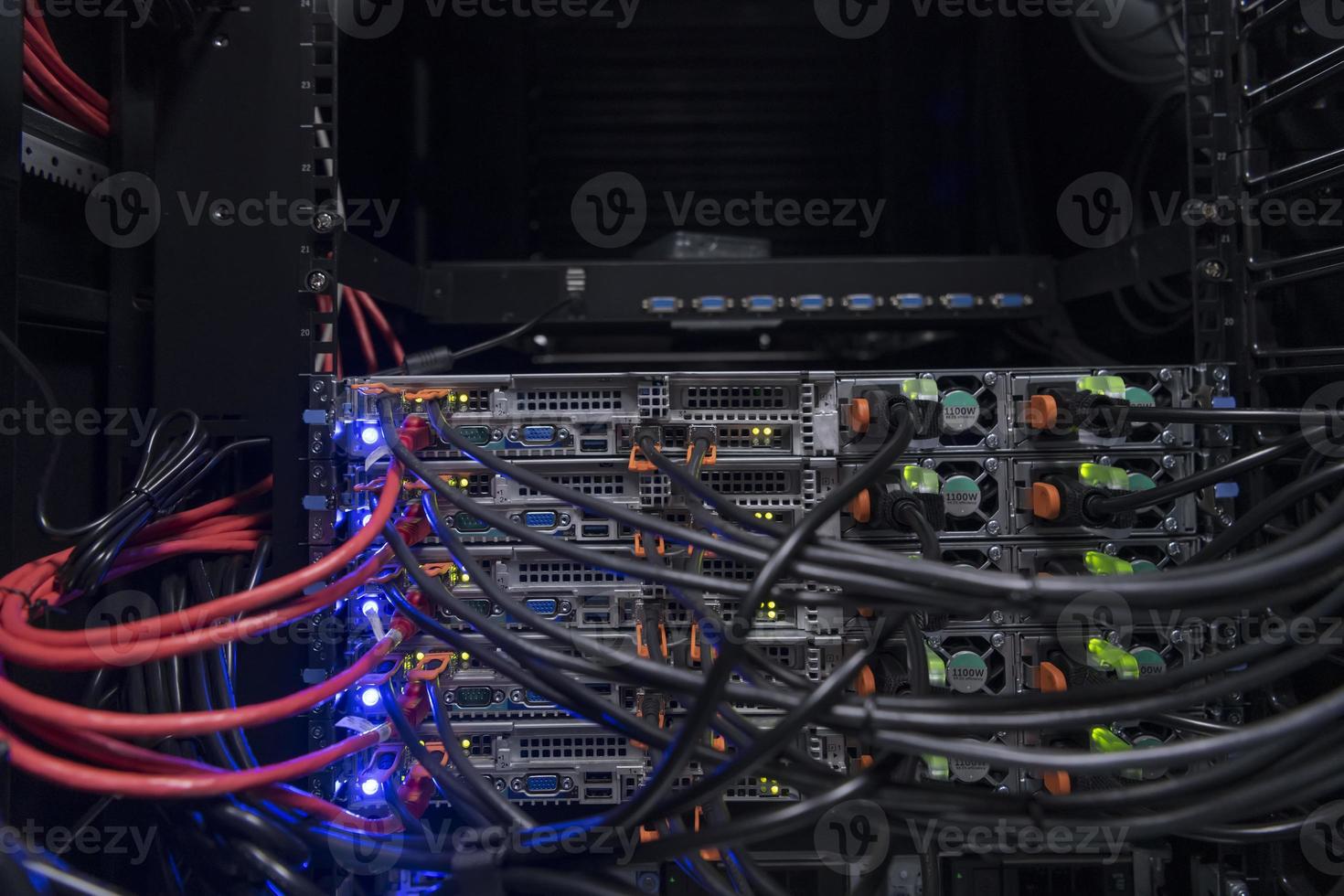 network server room closeup on fiber optic hub or switch for digital communications and internet in mainframe corporate business data center supercomputer. photo