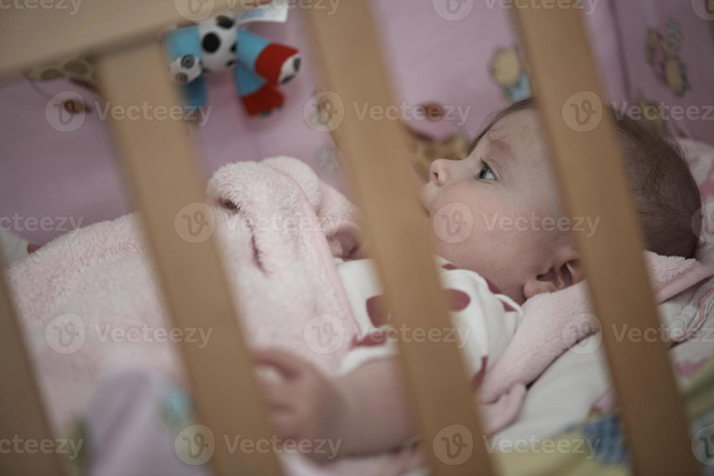 cute little baby playing with hands and smiling photo