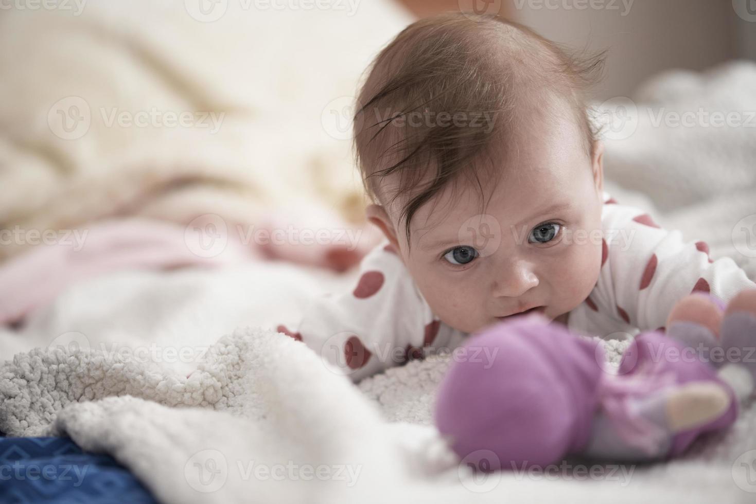 cute little baby playing with hands and smiling photo