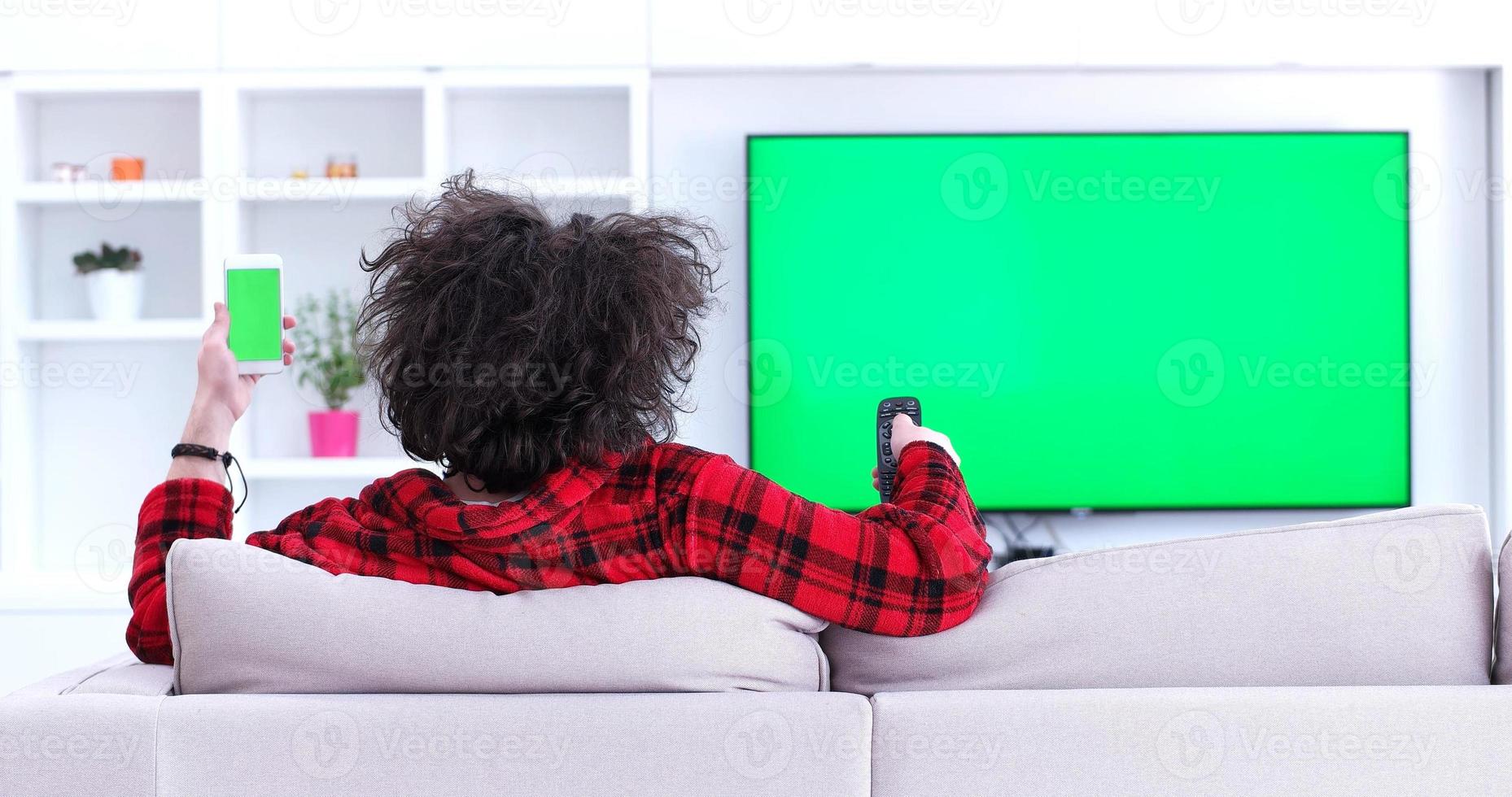 Young couple on the sofa watching television photo