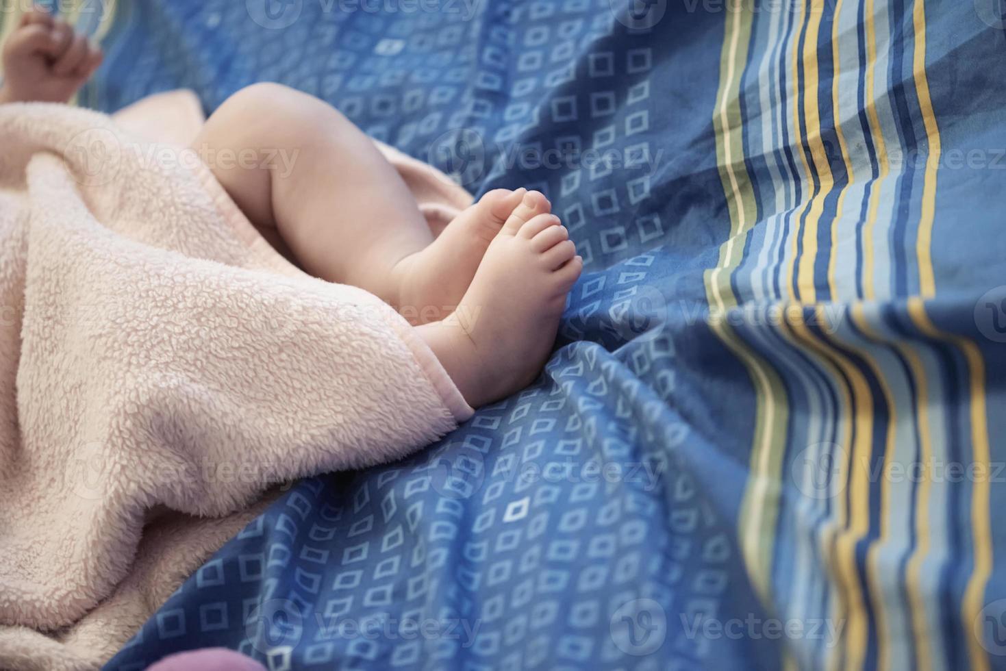 cute little baby playing with hands and smiling photo