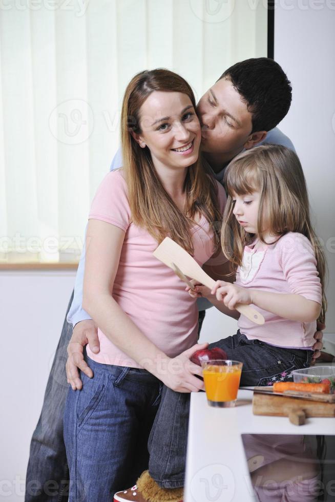 happy young family in kitchen photo